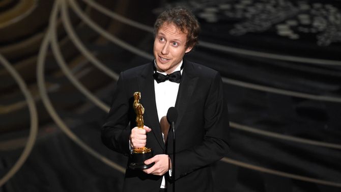 Laszlo Nemes, of Hungary, accepts the award for best foreign language film for “Son of Saul” at the Oscars on Sunday, Feb. 28, 2016, at the Dolby Theatre in Los Angeles. (Photo by Chris Pizzello/Invision/AP)
